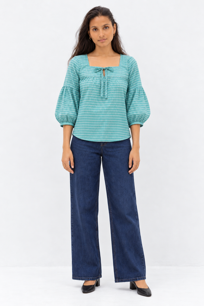 Green and white striped balloon sleeve top styled with denim