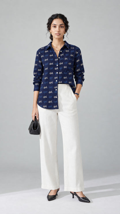 Woman wearing the navy Aqua Print pure cotton shirt with white wide-leg trousers, front view
