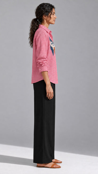 Ice red shirt showing the hand-embroidered abstract face motif at the left chest