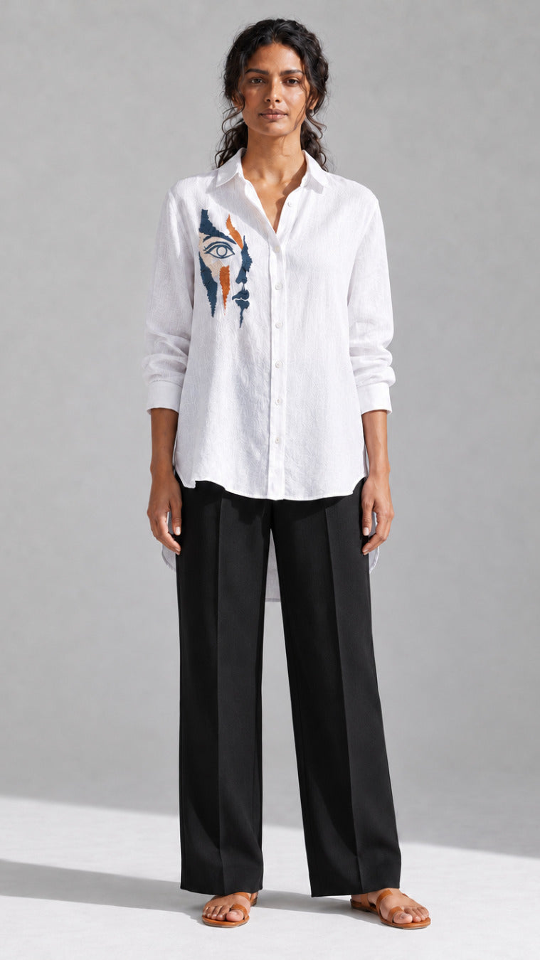 White face embroidered cotton linen shirt worn with black wide-leg trousers, front view
